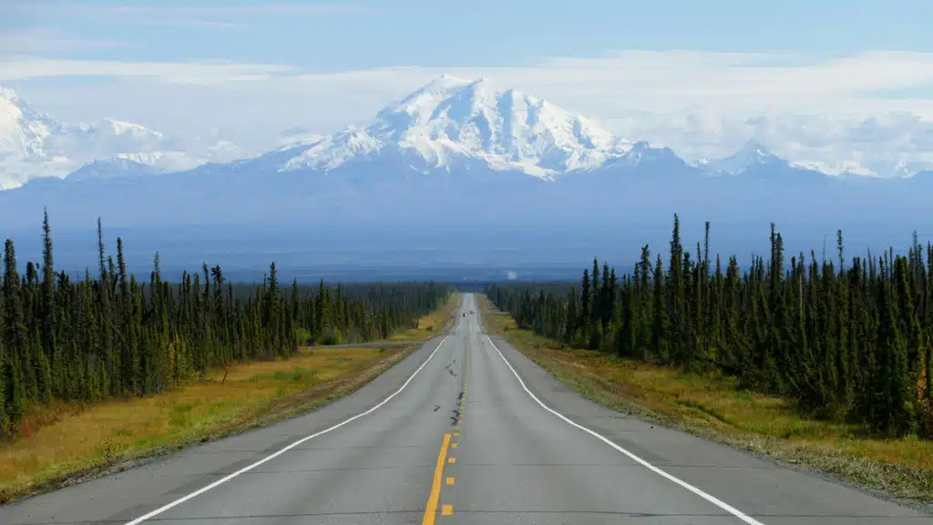 An open road in Alaska, leading up to a mountain. This is the type of terrain in question when wondering, "does Wayfair ship to Alaska".
