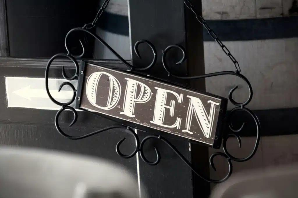 an OPEN sign is hung in front of a small business, to symbolize that they are open to the entire world via international shipping for small business.