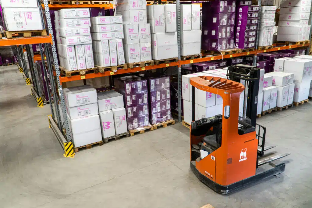 A top-down view of a warehouse, where a forklift is in a stock isle being used for order fulfillment.