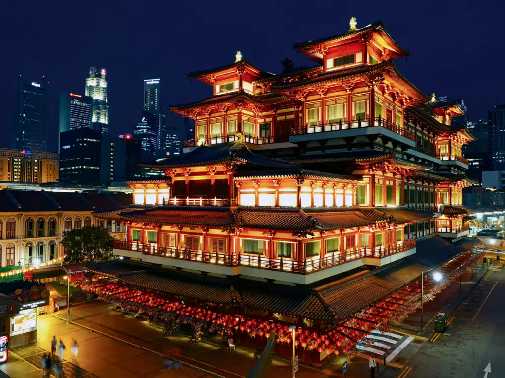 A traditional style building is lit up at night in Singapore.