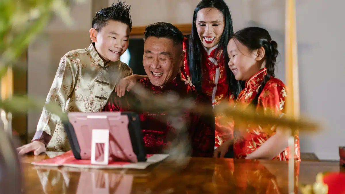 A happy family is using a tablet. You can sign up for PostFromUS from anywhere to ship from US to SG.