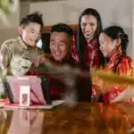 A happy family is using a tablet. You can sign up for PostFromUS from anywhere to ship from US to SG.