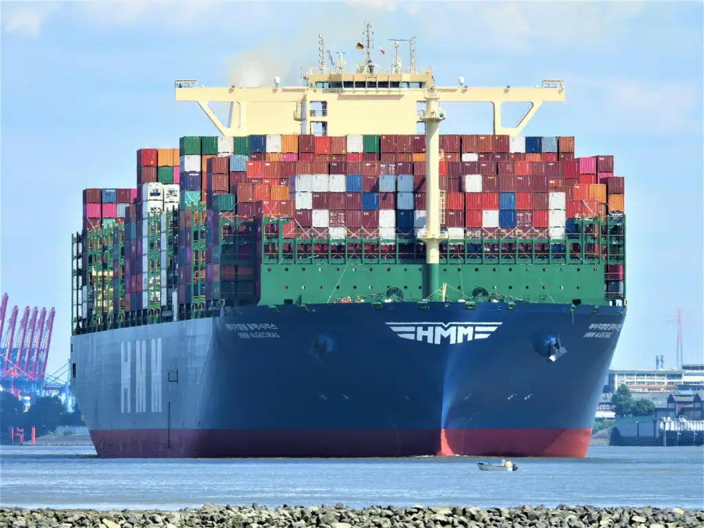 A ship for overseas shipping is fully loaded with cargo crates.