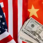 Shipping from US to China is being represented by a US flag on the left, Chinese flag on the right, and some cash in USD splayed out in the middle, like a fan.