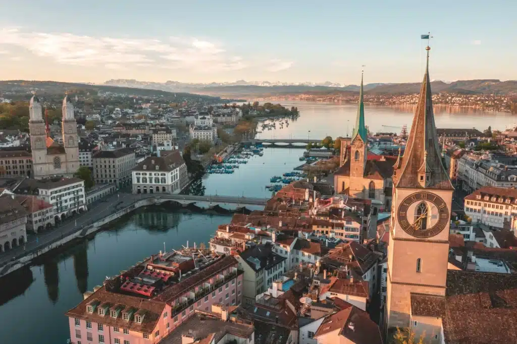 A sunny view of the city of Zurich, where shipping to Switzerland from US is easy with PostFromUS!