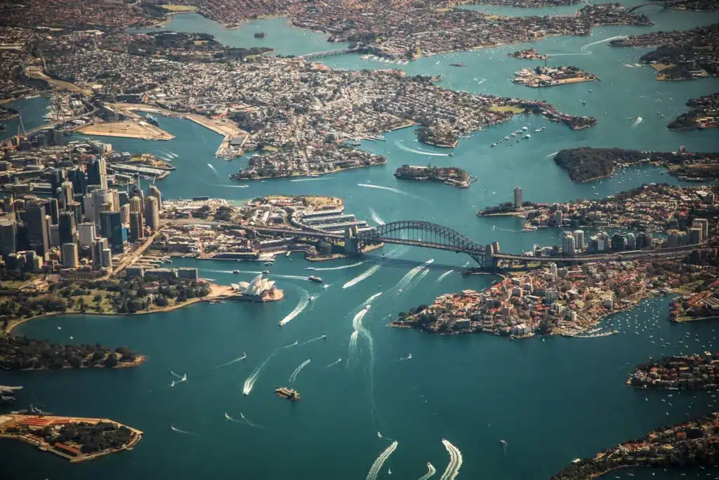 The Sydney Harbour photographed from the sky. Many of the boats pictured of shipping from USA to Australia.