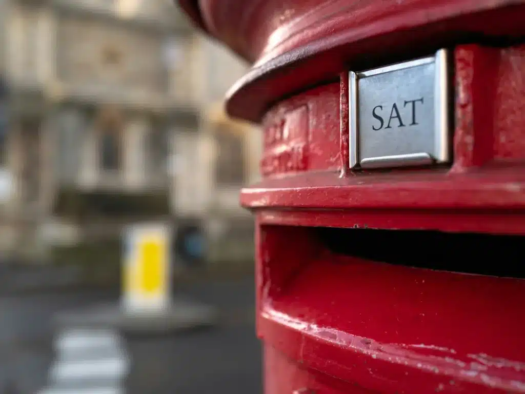 A red post box in the UK for shipping small parcels like envelope mailers.