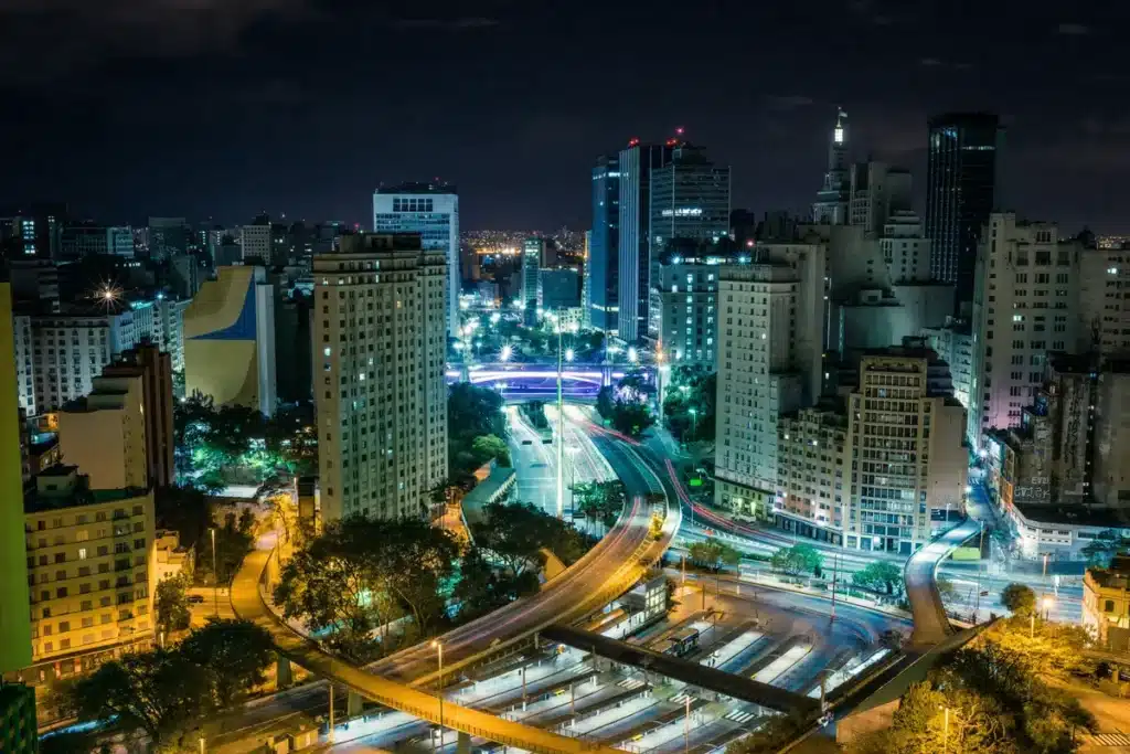 A city in Brazil at night time is bright with city lights.